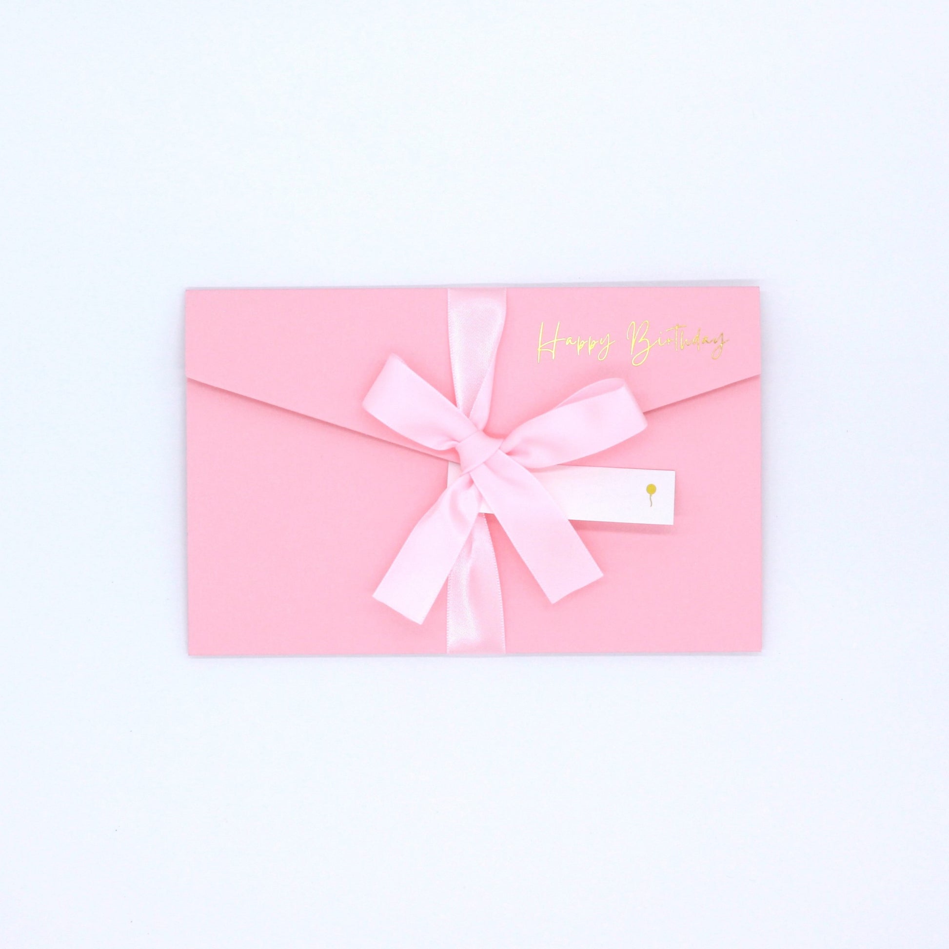 Pink pocket birthday greeting card with pink ribbon and white name tag